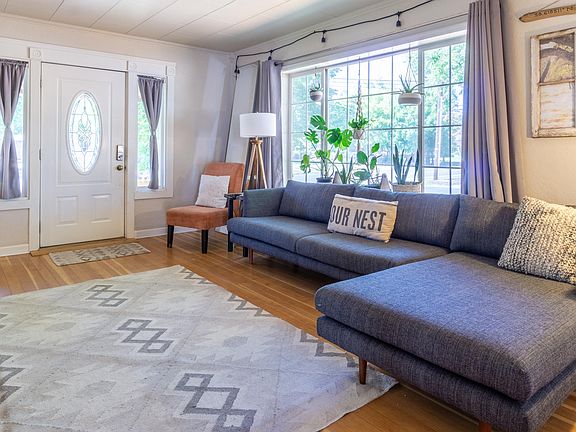 Living Room (couch, chair, floor lamp, dining table, plants, curtains, rug, decor included)