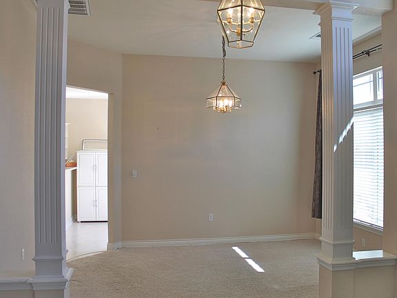 Beautiful formal dining room with kitchen just beyond