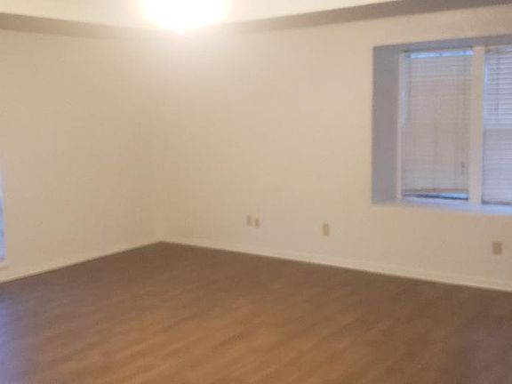 Spacious living area with new wood looking tile for easy upkeep.