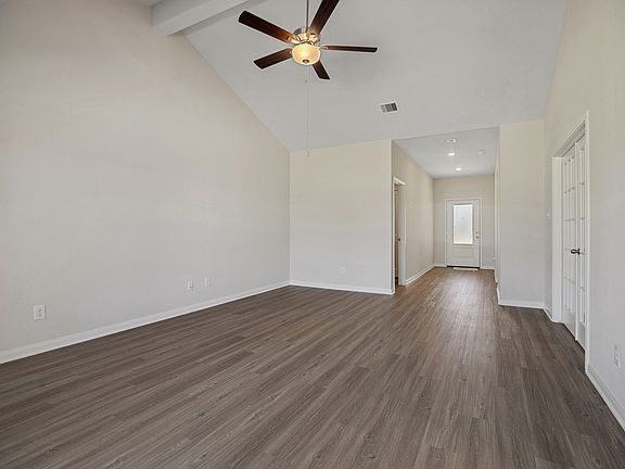 A foyer welcomes guests into a spacious family room