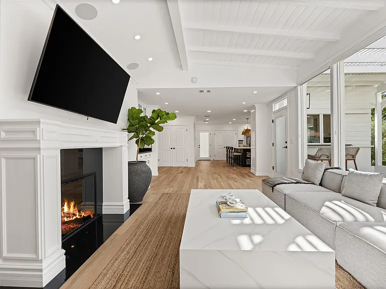 The lounge beckons with a massive TV, creating a haven for relaxation and entertainment.