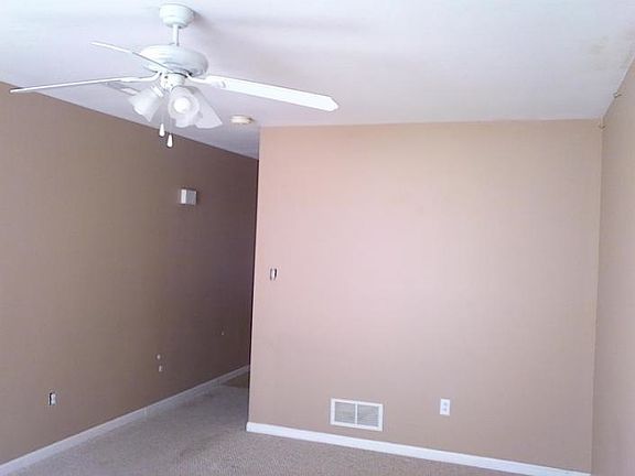 Living room leading into kitchen with stairs on the right
