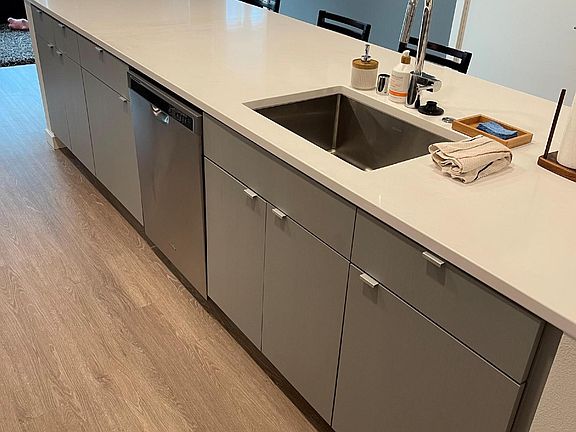 Large base cabinets with trash/recycling bin pull out under sink