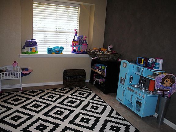 Originally the formal dining room, this room makes a great play room---easy for mom to supervise the children, with its location right off the kitchen.