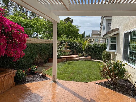 Spacious patio with fountain and decorative brickwork