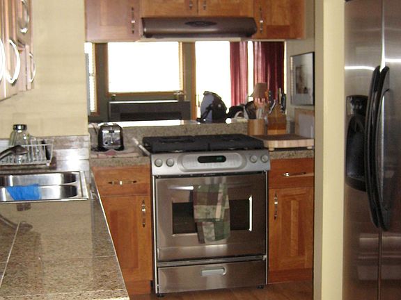 Granite counter tops and stainless steel appliances, as well as lots of cabinet space for storage. Windows on opposite ends of the living area gives lots of sunlight.