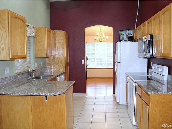 Kitchen with granite counters, tile floors and new appliances