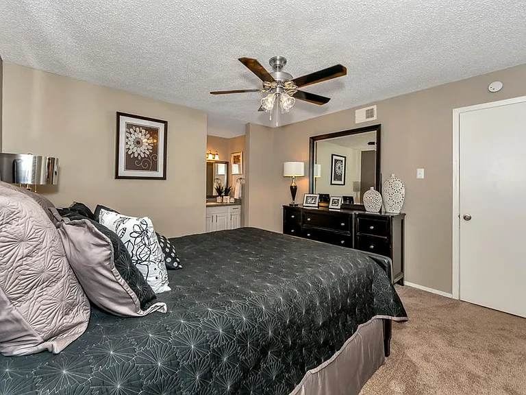 Comfortable bedroom with ceiling fan and natural lighting