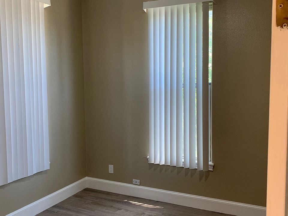 Bedroom #1 POV. New Vertical Blinds installed throughout the Home & New Remote Controlled Ceiling Fans Installed in every Bedroom & Kitchen.