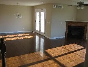 Living room with fireplace adjacent to dining are