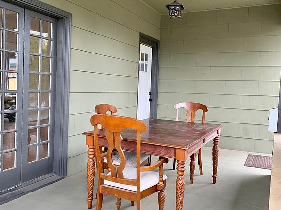 Roomy front porch with french doors to dining room.