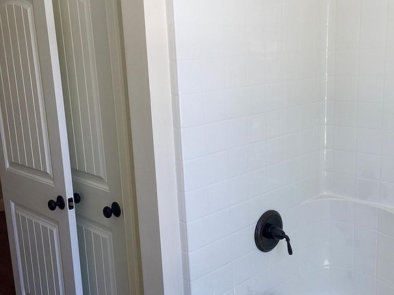 Bathroom closet and tub/shower combination unit.