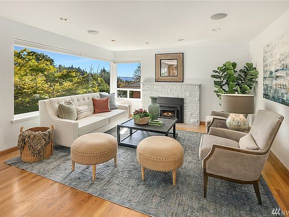 Living room boasts large picture window to showcase the view, cozy wood-burning fireplace for those chilly evenings and built-in speakers.