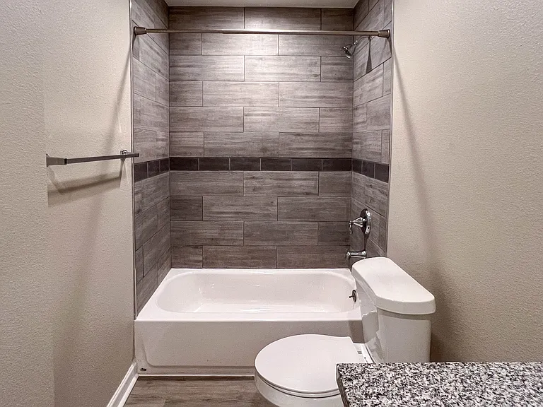 Tiled tub and shower combination adds a polished finish to the updated second bath.