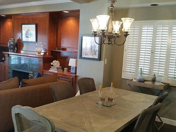 Dinning room table w/ view of fireplace in living room.