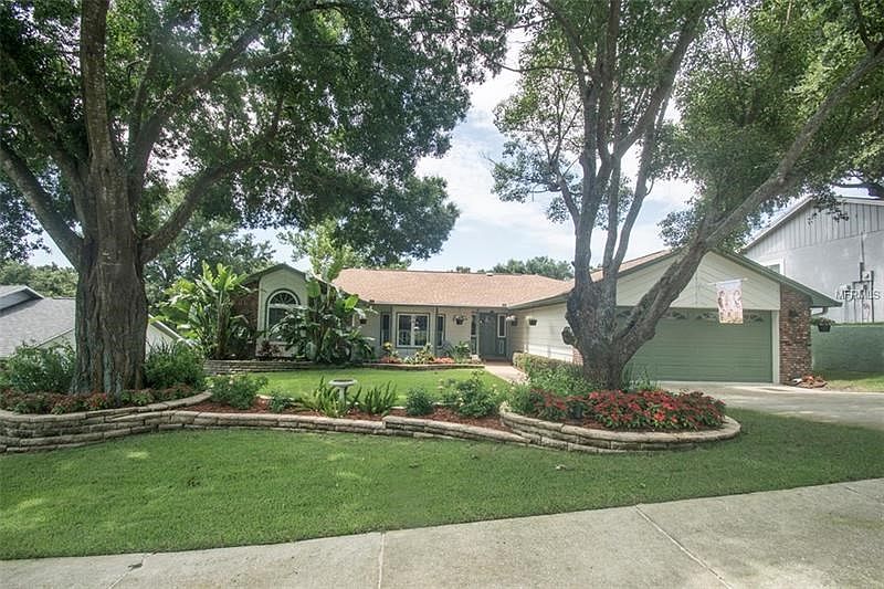 Neighborhood Award Winning Yard with Zoysia grass, brick landscaping beds and lush landscaping