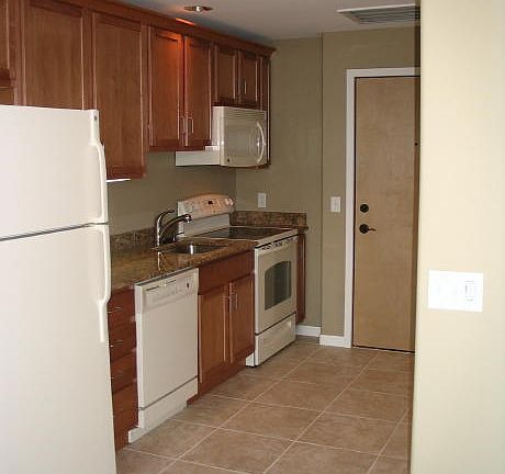 Full kitchen with oven, stove, refrigerator, freezer, dishwasher and garbage disposal.