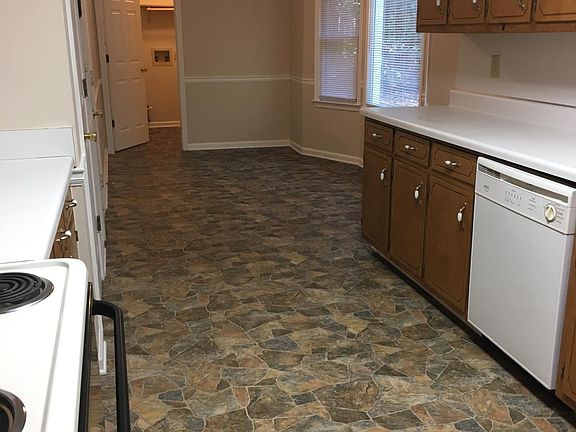 Spacious kitchen showing bay widow, laundry room.