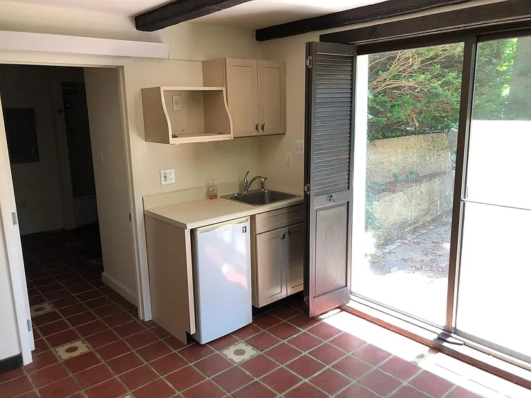Guest suite kitchen area and sliding door to patio