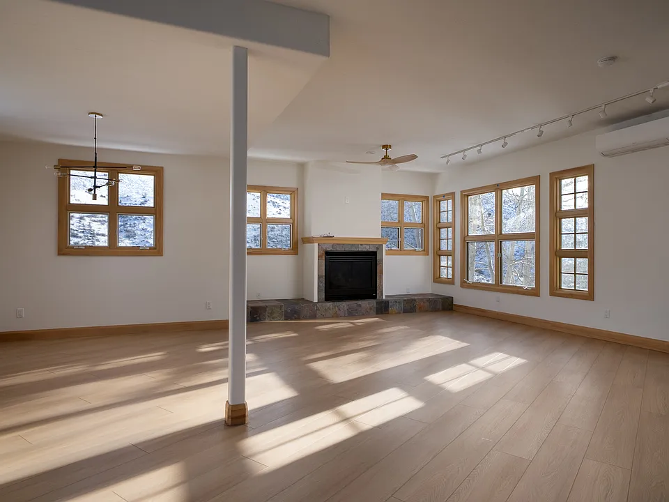 Spacious, light-filled great room with fireplace