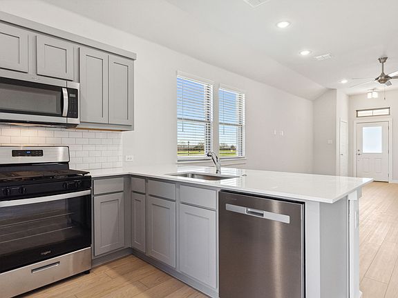 Kitchen in the Ash home plan by Trophy Signature Homes - REPRESENTATIVE PHOTO