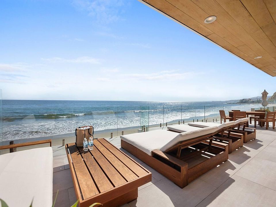 Expansive beachfront deck with unparalleled panoramic views of the ocean coastline.