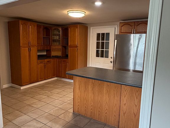 additional kitchen cabinets and area for kitchen table