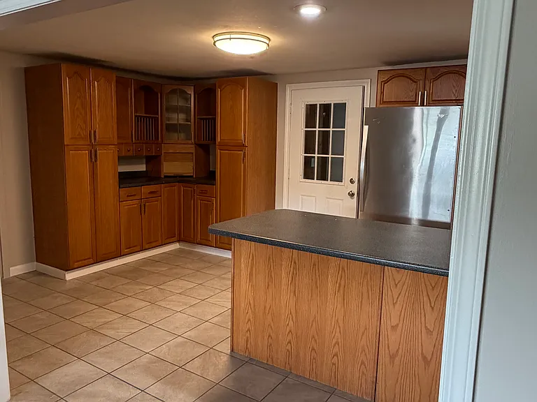 additional kitchen cabinets and area for kitchen table