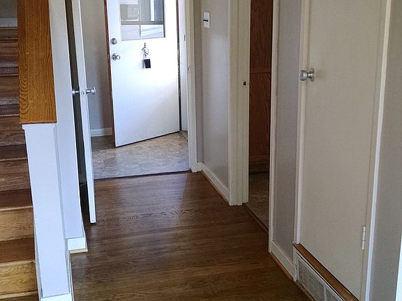 Entryway Hall with stairs to left, door to kitchen to the ri