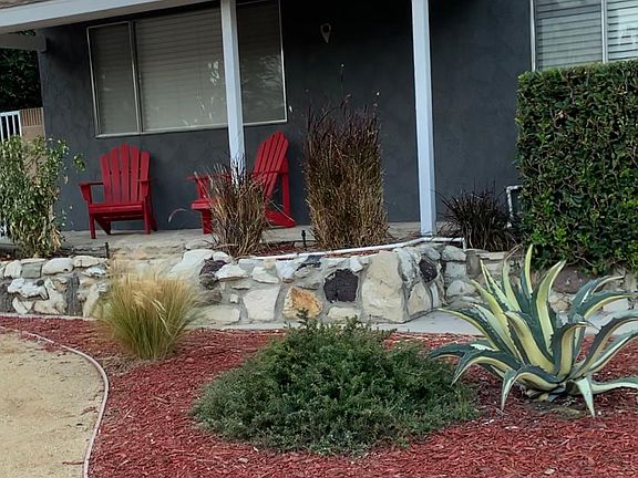 Adirondack chairs on front porch in quiet neighborhood