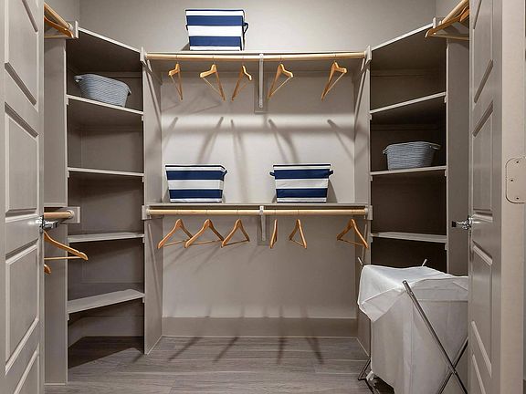 Oversized Walk-In Closet with Custom Built-In Shelving and Hanging Rods