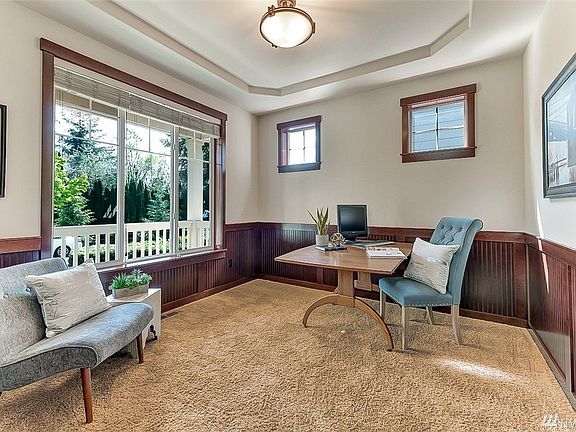 Den/possible bedroom has plenty of space and nice big windows and coffered ceiling. Notice the wainscotting too!