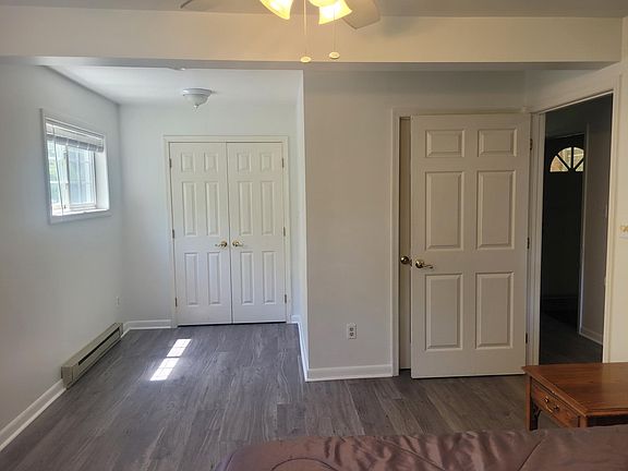 Closet doors opposite bed. Door on right is bathroom.