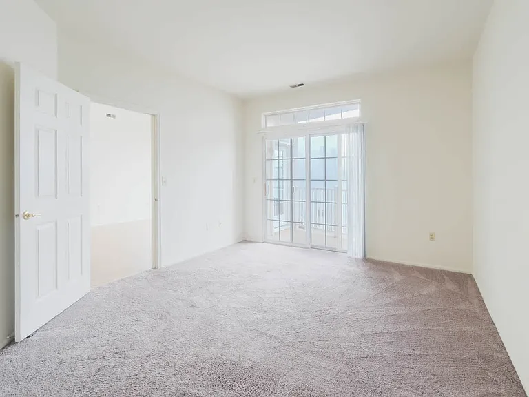 Carpeted Bedroom with Balcony