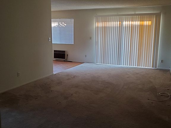 Large, long living room with sliding glass door to 30' long patio