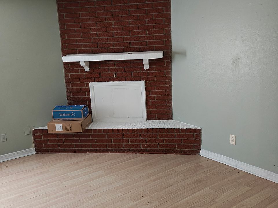 Spacious living room freshly painted with new flooring throughout.