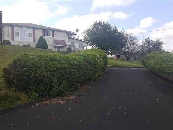 Second driveway between the pool and house