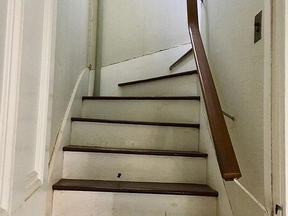 Painted turned stairs leading to second floor.