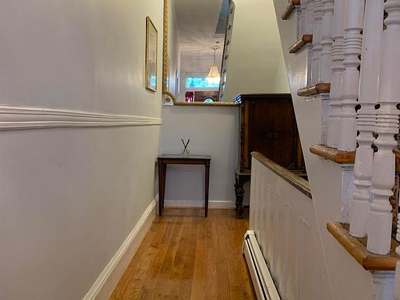 hallway leading to shared laundry in the basement