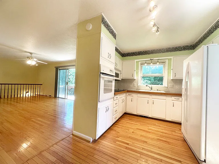 View from dining area into kitchen and second living room.