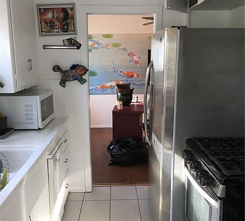 Partially upgraded Galley Kitchen with newer appliances and new dishwasher.