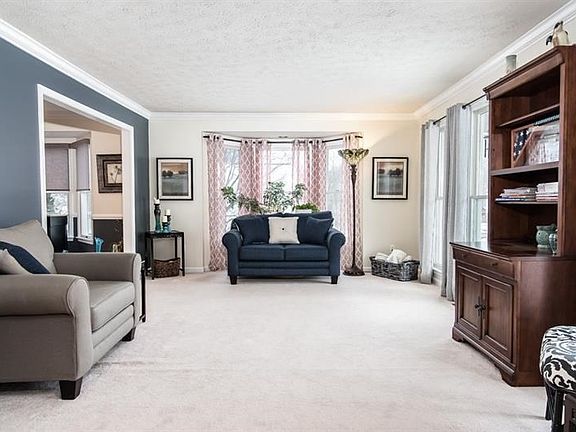 Living room with bay window and full length windows