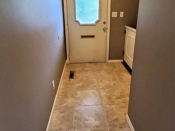 Front door, foyer, stairs on right.