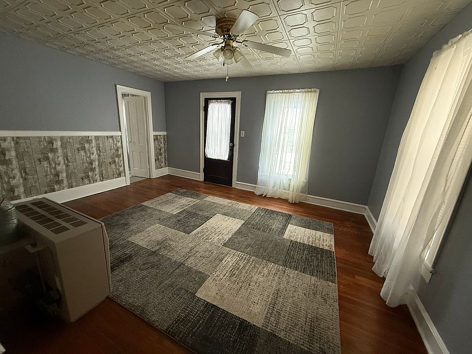 Look at this living room
 Get a load of the hardwoods, the ceiling fan and the tile ceiling.