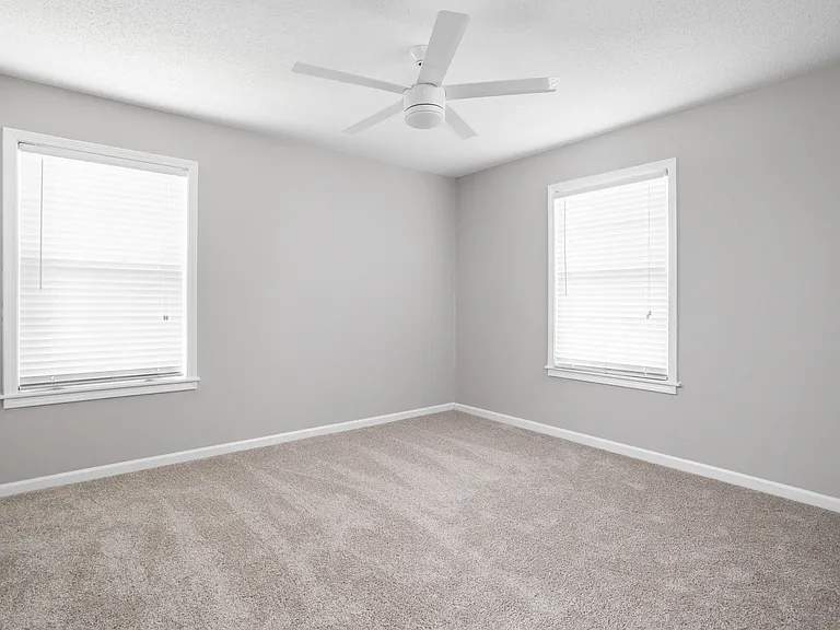 Spacious bedroom with ceiling fan