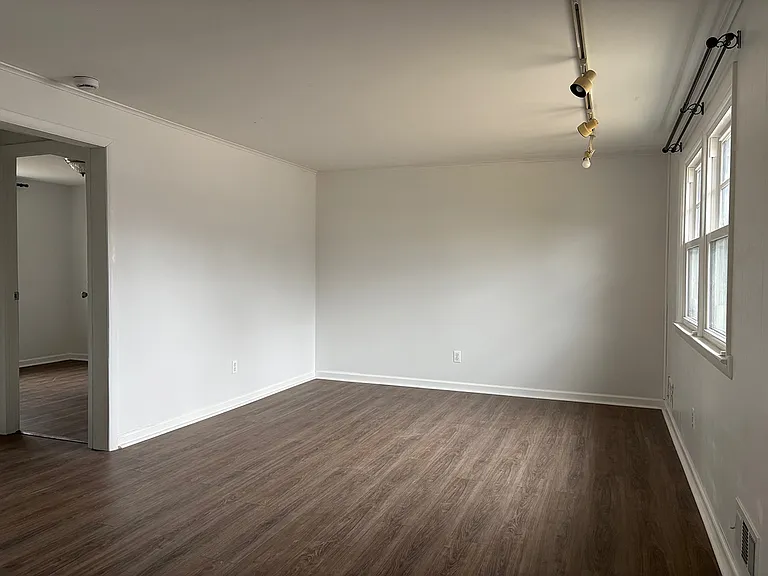 Common area at front entry door with hallway to downstairs bedroom/office, laundry room and 1/2 bath.
