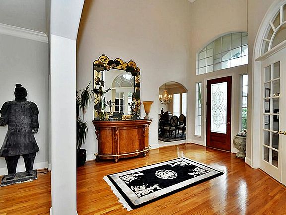 SOARING CEILINGS AND GLEAMING HARDWOOD FLOORS GREET YOU AS YOU ENTER THE HOME