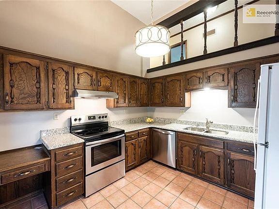 Kitchen has brand new granite countertops, stainless appliances, undermount sink and faucet, and lighting. Cabinets are beautifully maintained.