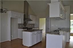 Kitchen w/corian countertops, island & snack bar