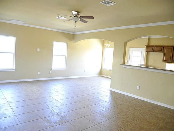 Gigantic Living Room With Tile Floors Open To The Kitchen*Ceiling Fan.